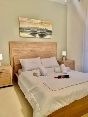 a bedroom with a large white bed with two pillows at Casa de Campo 1 in Almirida