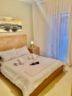a bedroom with a large bed with a large window at Casa de Campo 1 in Almirida