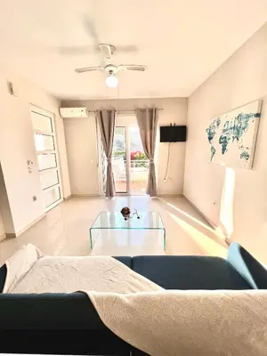 a living room with a couch and a glass table at Casa de Campo 1 in Almirida