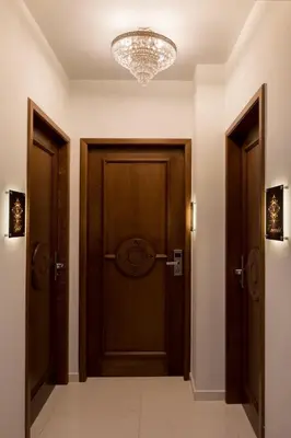 a hallway with two wooden doors and a chandelier at Vener Luxury Suites in Chania Town