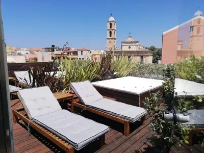 a patio with chairs and tables on a roof at Vener Luxury Suites in Chania Town
