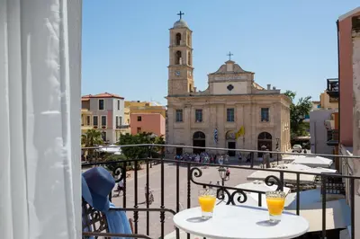 a balcony with two tables with orange drinks on it at Vener Luxury Suites in Chania Town
