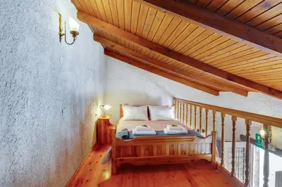 a bedroom with a bed and a wooden ceiling at Traditional Home Vereniki With Heated Pool - BY APOKORONAS VILLAS in Gavalochori