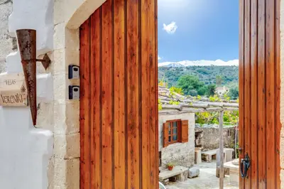 an open wooden door of a house with a view at Traditional Home Vereniki With Heated Pool - BY APOKORONAS VILLAS in Gavalochori