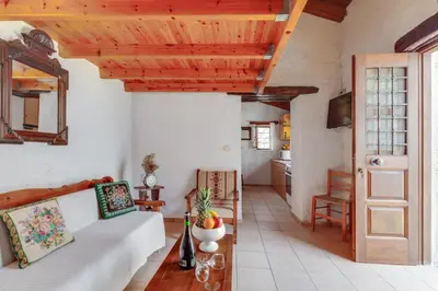 a living room with a couch and a table at Traditional Home Vereniki With Heated Pool - BY APOKORONAS VILLAS in Gavalochori