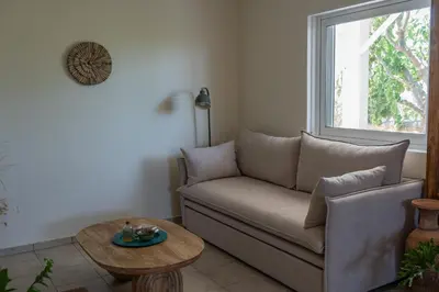 a living room with a couch and a table at Tranquility House in Livadia