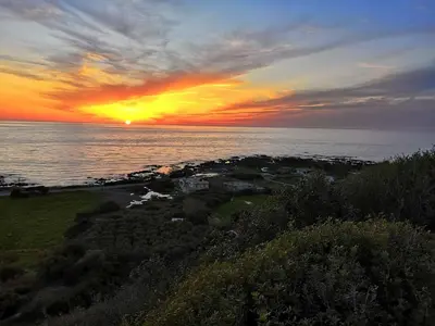 a sunset over the ocean with the sun setting at Tranquility House in Livadia