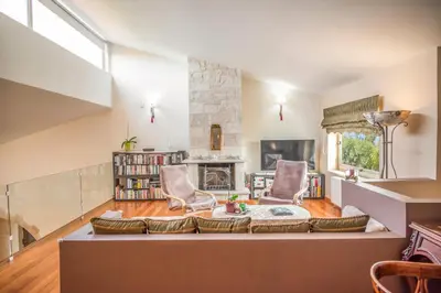 a living room with a couch and chairs and a fireplace at Orange Tree Garden vacation home in Ayiá