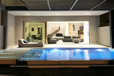 a swimming pool in a living room with a couch at NV One in Chania Town