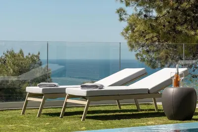 two lounge chairs sitting next to a swimming pool at NV One in Chania Town