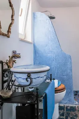 a bathroom with a blue sink and a toilet at MaGea-Thalassa,Top floor Cretan studio with views in Tavronitis
