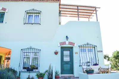 a blue house with a blue door and windows at MaGea-Thalassa,Top floor Cretan studio with views in Tavronitis