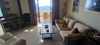 a living room with a couch and a table at Vasiliki's Residence - Breathtaking View in Kissamos