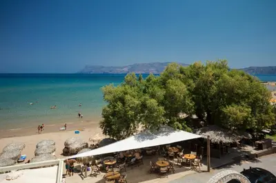 a view of a beach with people in the water at Mavros Molos Seaside Apartment in Kissamos