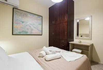 a bedroom with a bed with towels on it at Mavros Molos Seaside Apartment in Kissamos