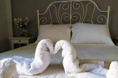 two towels in the shape of a heart on a bed at Sunday Apartment Chania 2A in Chania Town