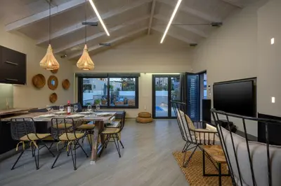 a dining room with a table and chairs at Sun Ray Beach Life Villa in Agia Marina Nea Kydonias
