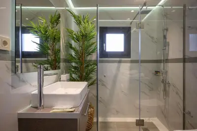 a bathroom with a sink and a shower at Sun Ray Beach Life Villa in Agia Marina Nea Kydonias