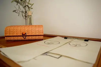 a table with two sheets of paper and a box at Kanso Rooms in Galatás
