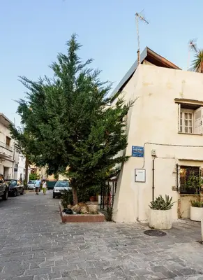a tree in front of a building with a tree at House Erofili in Chania Town