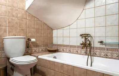 a bathroom with a toilet and a bath tub at Microcosmos Halepas in Chania Town