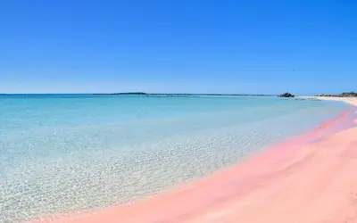 a beach with pink sand and blue water at Sea Lake Holiday House in Elafonisi