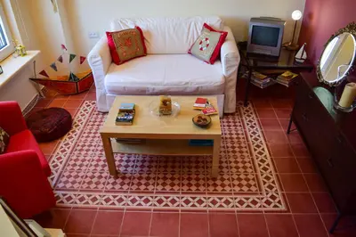 a living room with a white couch and a table at MaGea- Asterias Ground floor peaceful apartment in Tavronitis