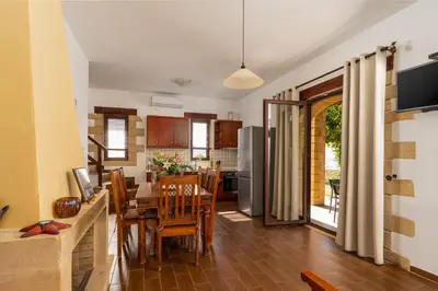 a kitchen and dining room with a table and chairs at Stay in Falassarna Villas in Falasarna