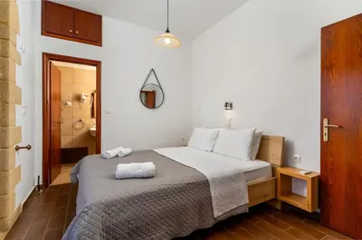 a bedroom with a bed with two towels on it at Stay in Falassarna Villas in Falasarna