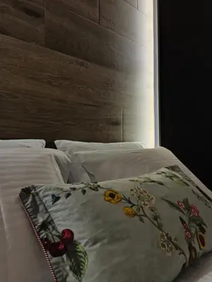 a bed with a blanket on top of it at MOS Luxury City Suites - The R suite in Chania Town