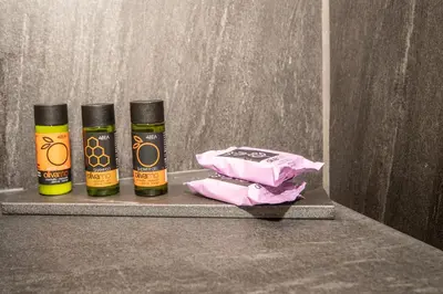 two bottles of essential oils sitting on a shelf at MOS Luxury City Suites - The R suite in Chania Town