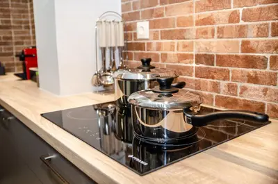 a kitchen counter with two pots on a stove at MOS Luxury City Suites - The R suite in Chania Town