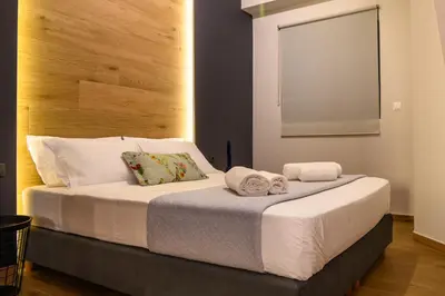 a bedroom with a bed with towels on it at MOS Luxury City Suites - The R suite in Chania Town