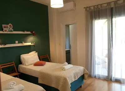 a room with two beds and a window at Chania Olive Home in Kato Daratso