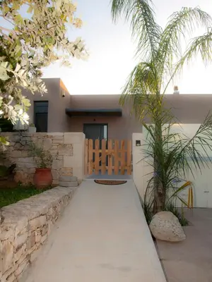 a walkway leading to a house with a gate at Chania Olive Home in Kato Daratso