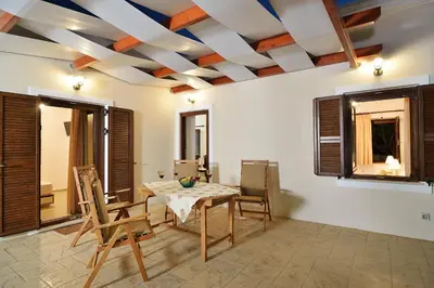 a dining room with a table and chairs at Anna 's House - Garden Cottage in Kissamos in Kissamos