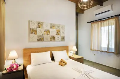 a bedroom with a teddy bear sitting on a bed at Anna 's House - Garden Cottage in Kissamos in Kissamos