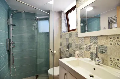 a bathroom with a glass shower and a sink at Anna 's House - Garden Cottage in Kissamos in Kissamos