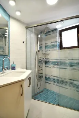 a bathroom with a glass shower and a sink at Anna 's House - Garden Cottage in Kissamos in Kissamos
