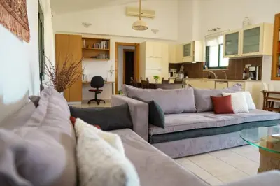 a living room with a couch and a kitchen at Villa Christina Anidri in Ánidhroi