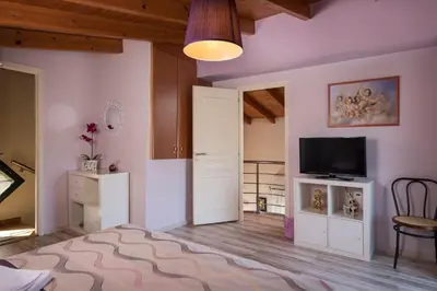 a large living room with a television and a door at Villa La Palma in Vrísai