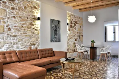 a living room with a couch and a table at The Well in Chania Town