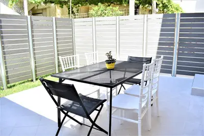 a black table with chairs and a potted plant on it at The Well in Chania Town