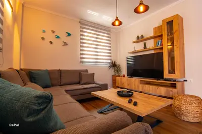 a living room with a couch and a flat screen tv at Bitsakis Family I - Paleochora Luxury House in Palaiochóra