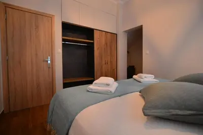 two twin beds in a room with towels on them at Bitsakis Family I - Paleochora Luxury House in Palaiochóra