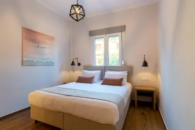 a bedroom with a large white bed with two pillows at Bitsakis Family I - Paleochora Luxury House in Palaiochóra