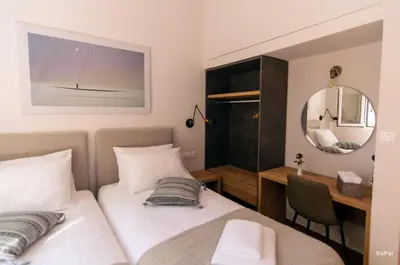 a bedroom with a bed and a desk and a mirror at Bitsakis Family I - Paleochora Luxury House in Palaiochóra