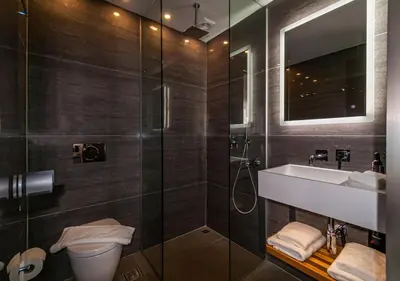 a bathroom with a toilet and a sink and a shower at Epavli Boutique Hotel in Chania Town