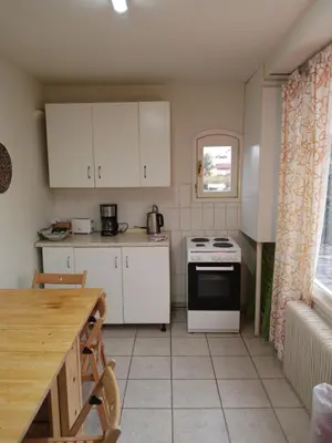 a kitchen with white cabinets and a stove top oven at house in the village near the sea in Maleme