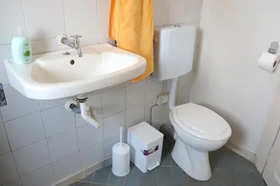 a bathroom with a toilet and a sink at house in the village near the sea in Maleme